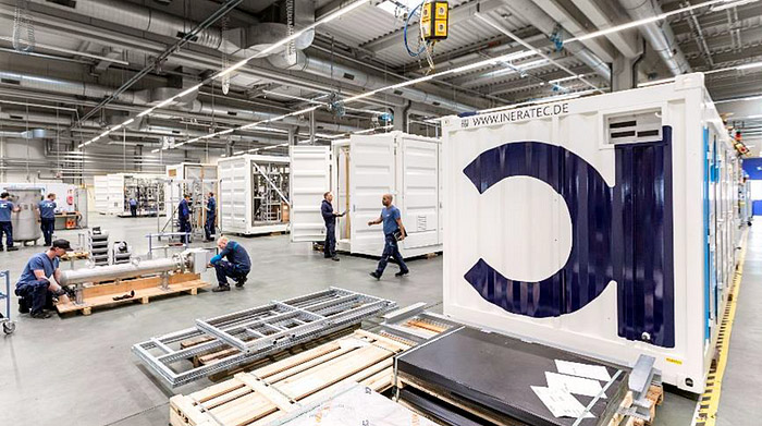 Workers in INERATEC’s Karlsruhe production facility assembling large equipment.