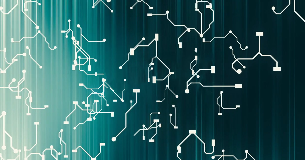 Close-up of a green circuit board with white electronic patterns.