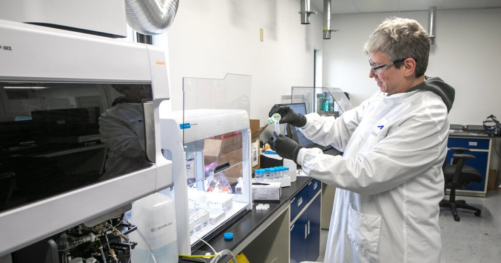 Laboratory technician using scientific equipment in a modern lab.