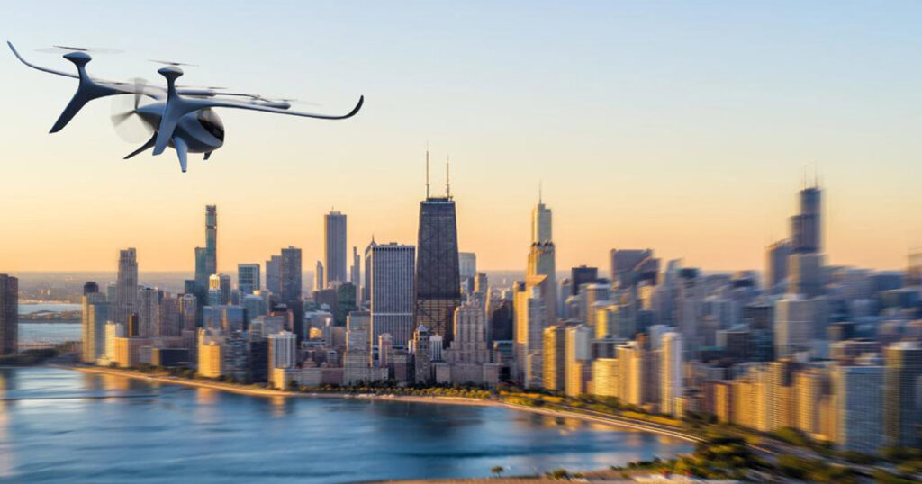 Autoflight drone flying over a city skyline during sunset.