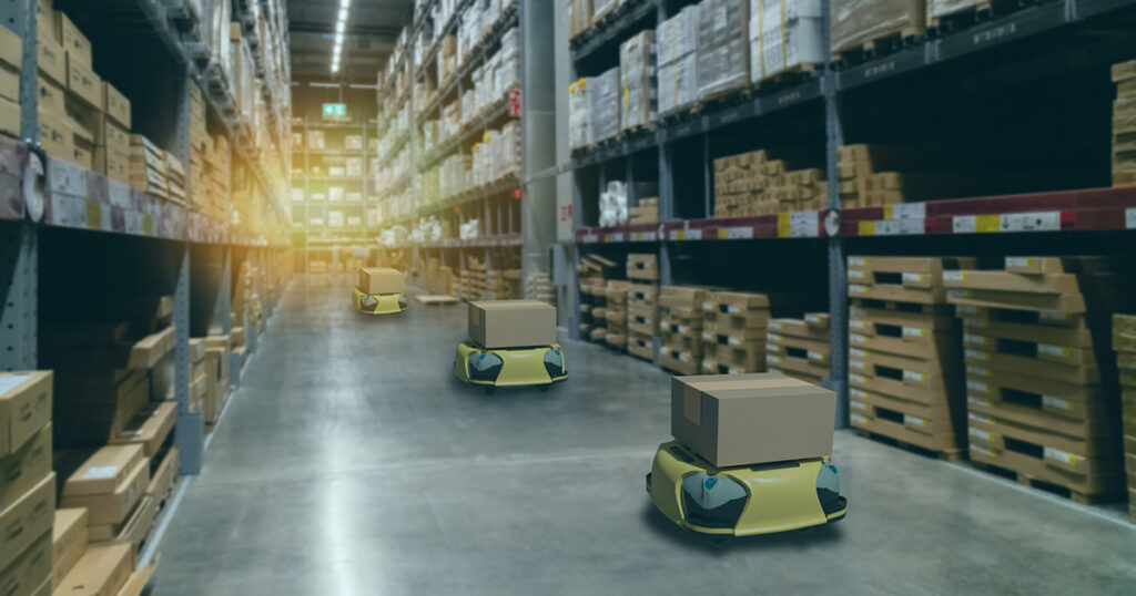 Autonomous robots transporting goods in a modern warehouse aisle.