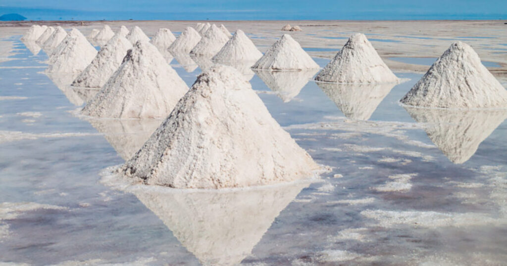 Salt pyramids in Salar de Uyuni, Bolivia reflecting in water.