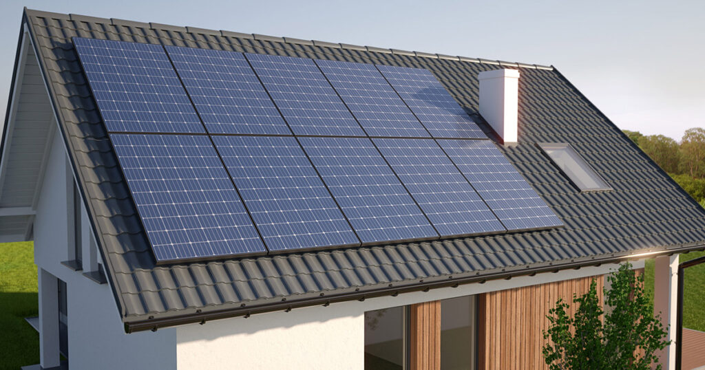 Solar panels installed on a modern house's roof against a clear sky