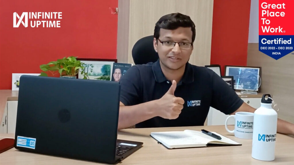 Man giving thumbs up in an office setting.