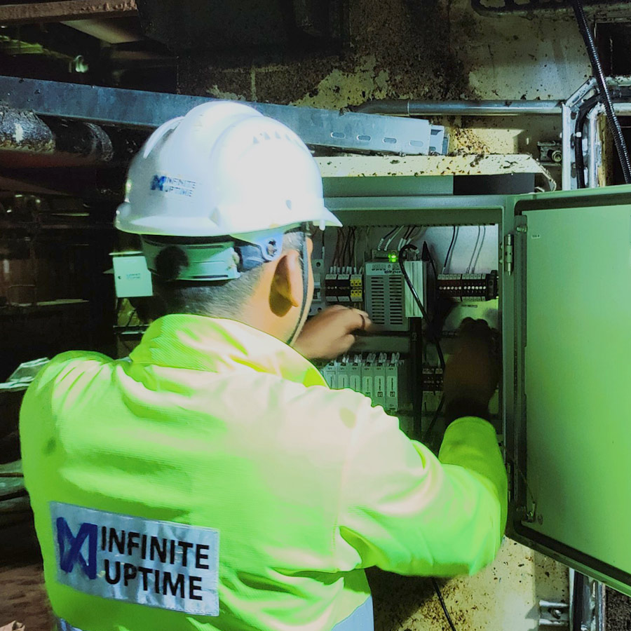 Technician inspecting electrical panel.