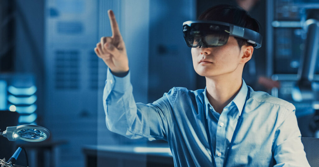 Person using augmented reality headset in a high-tech lab setting.