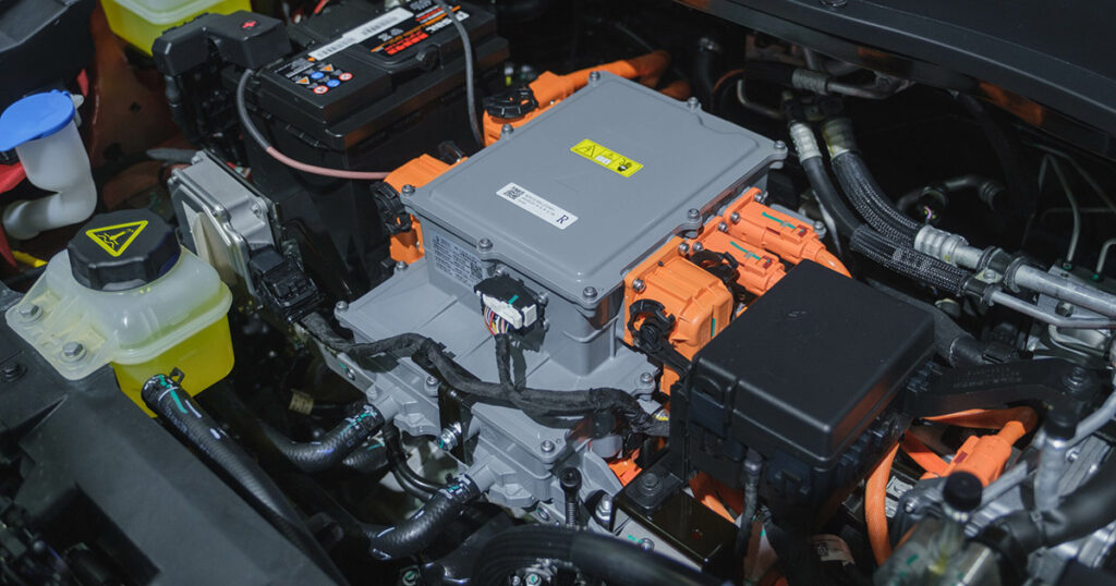 Detailed view of an electric vehicle's engine bay highlighting the battery and components.