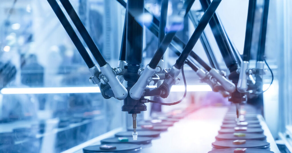 Robotic arm on an industrial assembly line manufacturing products.