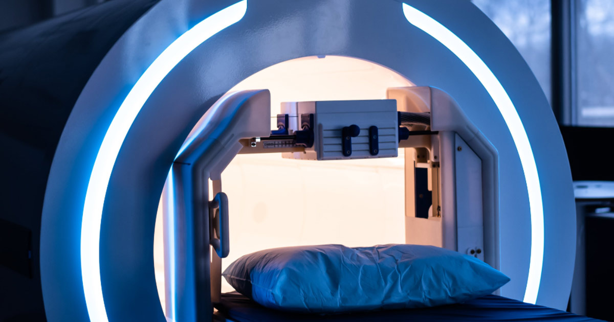 Genetesis modern MRI scanner with blue neon lights in a medical facility.