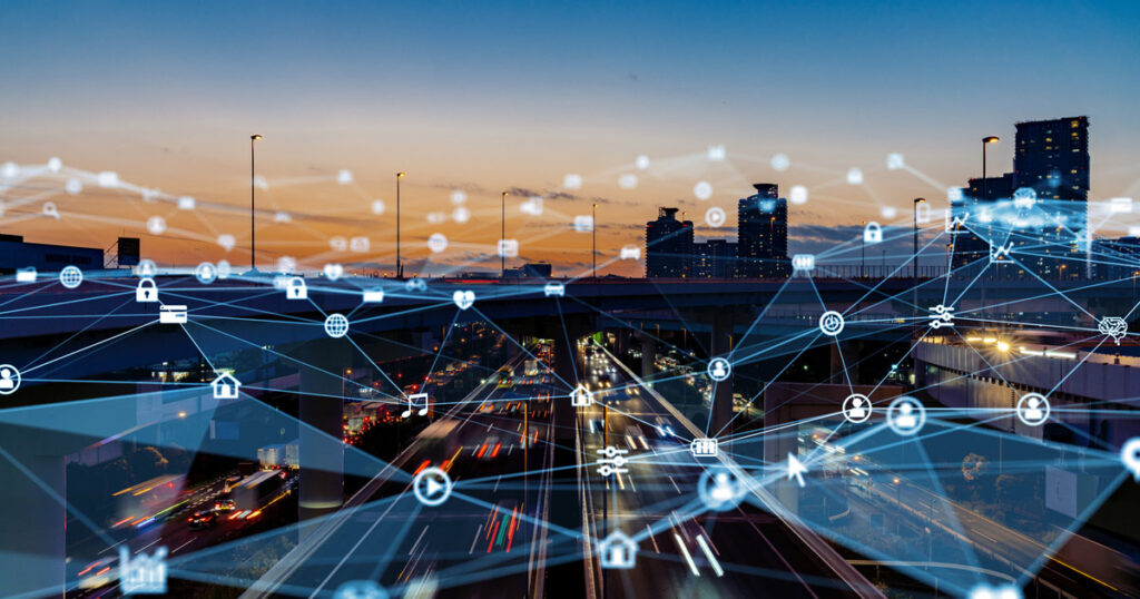 Smart city concept with digital network overlaying a bustling highway at dusk.